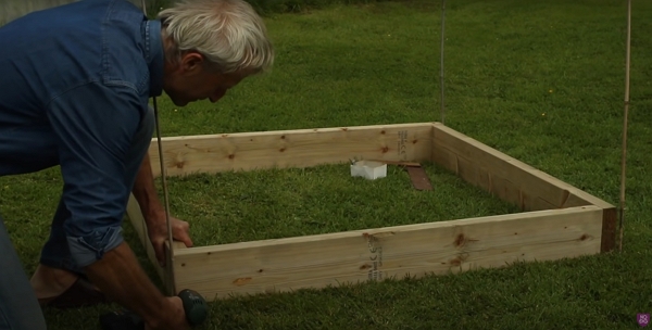 Charles using a drill to set the screws in