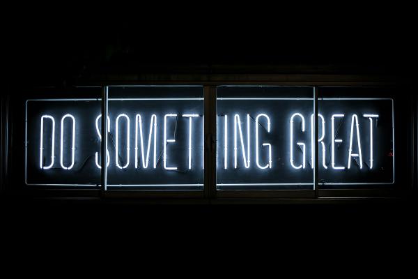 A "Do Something Great" sign in the dark