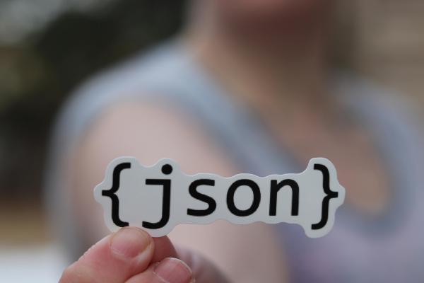 A JSON sticker held by someone