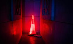 Illuminated road work cone in the dark