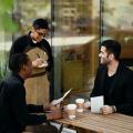 A waiter taking an order from two men