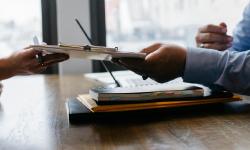 Two persons exchanging a document