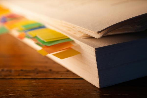 a stack of books sitting on top of a wooden table