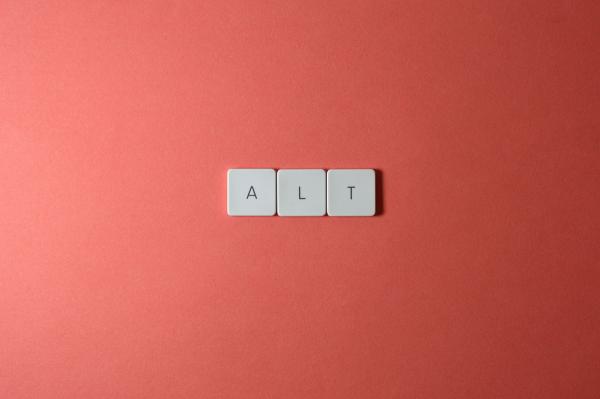 Keys A-L-T aligned on salmon-color background