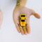 Free Pair of adult hands holding green and yellow toy cars on a white surface, symbolizing choice.